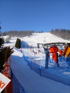 a ski slope with people on a ski lift at Willa Gloria in Zakopane