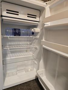 an open refrigerator with a bottle of water in it at Petraone in Wadi Musa