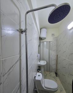 a small bathroom with a toilet and a shower at Petraone in Wadi Musa +29 photos