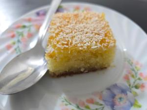a piece of cake on a plate with a spoon at Petraone in Wadi Musa