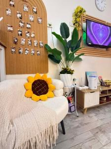a room with a bed with a yellow flower on it at The Fyangz Luxe Staycation Near Anjo World in Cebu