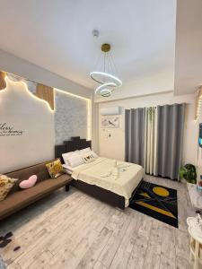 a bedroom with a bed and a couch at Fyangz Mini Karaoke Condo Staycation in Minglanilla +20 photos