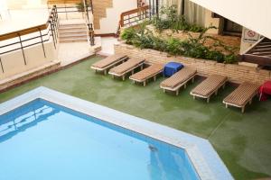 an overhead view of a swimming pool with lounge chairs at Gaddis Hotel, Suites and Apartments in Luxor