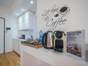 a kitchen counter with a coffee sign on the wall at Bartolo Suite Centro Storico Perugia in Perugia