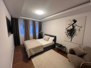 a small bedroom with a bed and a couch at Davids place 2 in Floreşti +28 photos