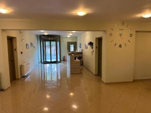 a hallway with a large clock on the wall at Evangelia in Agia Effimia