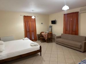 a living room with a bed and a couch and a table at Evangelia in Agia Effimia +227 photos