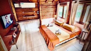 a bedroom with a large bed in a room with windows at Posada del Viento in Tandil