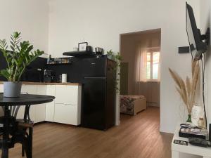 a kitchen with a black refrigerator and a table at AMA HOMe, appartamento in centro con terrazza in Ancona