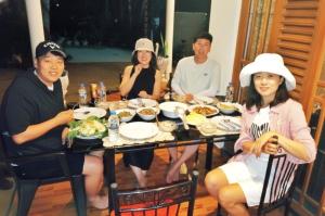 a group of people sitting around a table eating food at Yala Eagle Nest & Safari in Tissamaharama