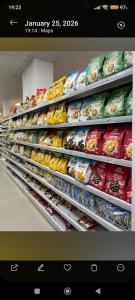 a store aisle filled with different types of food at Hydrovor Apartment & Room in Hamallë