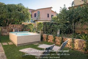 a swimming pool in the yard of a house at Villetta Bouganville in Budoni