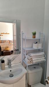 a bathroom with a sink and a toilet and a mirror at Nyumba in Colonia Nuevo Paysandú
