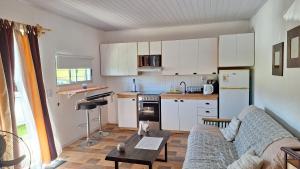 a living room with a couch and a kitchen at Nyumba in Colonia Nuevo Paysandú