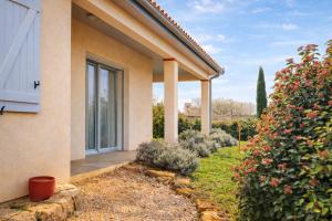 a house with a large window and a garden at Gite Lagarrigue in Lavaur