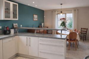 a kitchen with a table and a dining room at Gite Lagarrigue in Lavaur