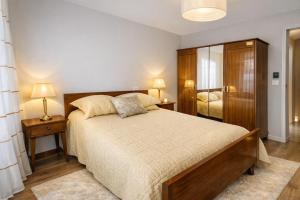 a bedroom with a large bed and two night stands at Gite Lagarrigue in Lavaur