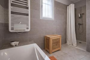 a bathroom with a tub and a window and a shower at Gite Lagarrigue in Lavaur +5 photos