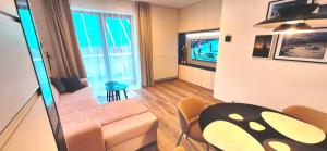 a living room with a couch and a table at Apartmán Riverside Labe Vrchlabí in Vrchlabí