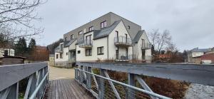 a building on a bridge in front of a building at Apartmán Riverside Labe Vrchlabí in Vrchlabí