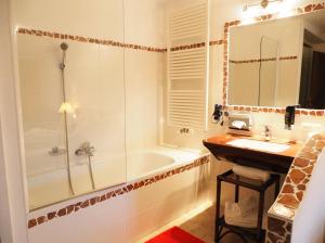 a bathroom with a tub and a sink and a shower at Erlachmühle in Mondsee +64 photos