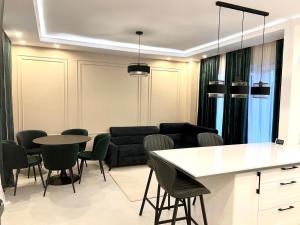 a living room with a couch and a table and chairs at Davids place 2 in Floreşti