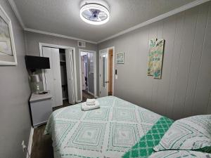 a bedroom with a bed and a television in it at BEACHSIDE CONDO-WATER AND POOL VIEW Top Floor in Tybee Island