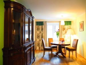 a dining room with a table and a large cabinet at Erlachmühle in Mondsee