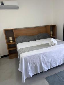 a bedroom with a bed with two towels on it at Brisa Mar Prime in Porto Seguro +7 photos