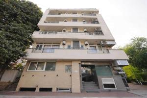 a tall building with balconies on the side of it at Hotel O Daffodils in Gurgaon +6 photos