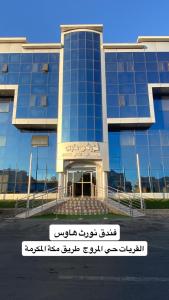 a building with a sign in front of it at Nourth House ApartHotel-شقق البيت الشمالي للشقق المفروشة in Al Qurayyat