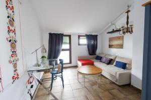 a living room with a couch and a table at La Casa del Risco Zahara in Zahara de la Sierra