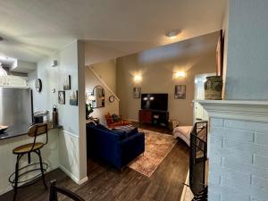 a living room with a blue couch and a tv at Gated Lakefront Retreat in Edmond