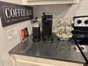 a counter top with a coffee bar on it at Gated Lakefront Retreat in Edmond +27 photos