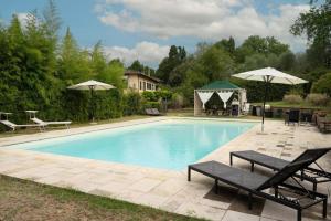 a swimming pool with two benches and umbrellas at Villa Morandi in Florence +7 photos
