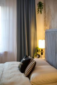 a bed with two pillows on it in a bedroom at Dan Apartament C, Self check-in in Opole