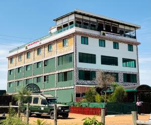 a green truck parked in front of a building at Mara Balanite Hotel in Masai Mara +12 photos