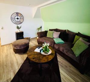 a living room with a couch and a table at Harz Flair Schierke in Schierke