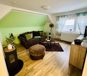 a living room with a couch and a table at Harz Flair Schierke in Schierke