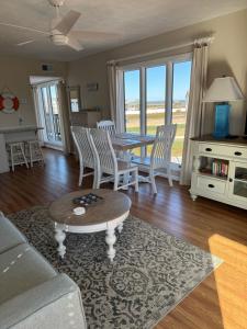 a living room with a couch and a table and chairs at Ocean Dream in Kitty Hawk Beach