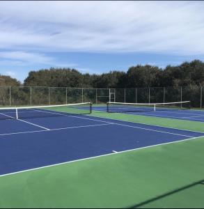 a tennis court with two tennis rackets on it at Ocean Dream in Kitty Hawk Beach