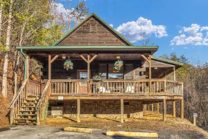 a large log cabin with a large deck at Mountain View Cabins in Tellico Plains