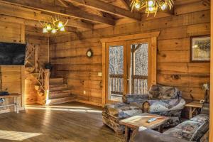 a living room with a couch and chairs in a cabin at Mountain View Cabins in Tellico Plains