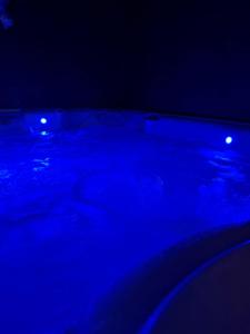 a dark room with blue lights on a car at Les Suites in Strasbourg
