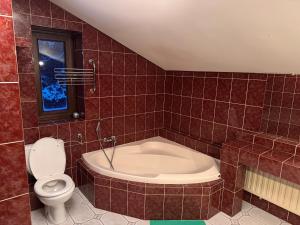 a bathroom with a tub and a toilet at Noclegi na Asfaltowej in Sulejówek
