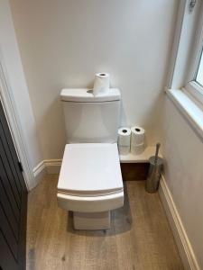 a bathroom with a toilet with two rolls of toilet paper at 1 Bed Room Flat Close to seafront in Weston-super-Mare