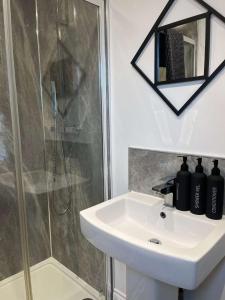 a bathroom with a sink and a shower at 1 Bed Room Flat Close to seafront in Weston-super-Mare