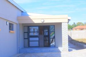 a building with a door on the side of it at Bataung Guest House in Mafeteng