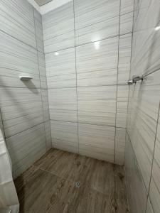 a bathroom with a shower with a wooden floor at Cusco - Flor de Loto in Cusco +35 photos