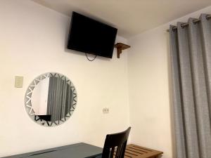 a room with a mirror and a tv on the wall at Cusco - Flor de Loto in Cusco
